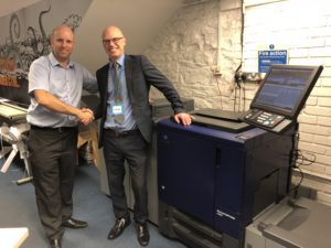 Phil Schueler, MJ Flood Production Print Manager with customer Colm Eglington